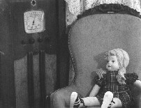 Old radio with doll in rocker